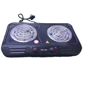 Black portable double electric coil cooktop with two burners, control knobs, and power cord on a white background